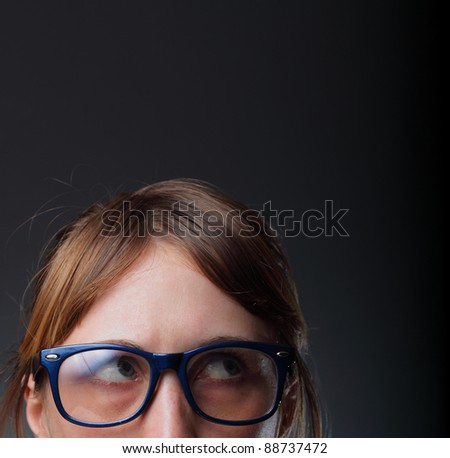 Nerd woman in glasses reading a book