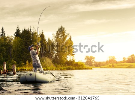 Fisherman with rod in the boat on the calm pond