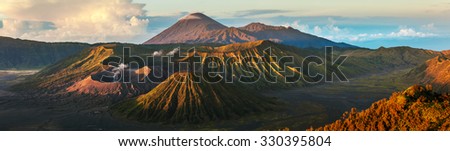 Panorama of the group of volcanoes in the National Park of Java island, Indonesia. Bromo (smoking), Batok, Semeru volcanoes
