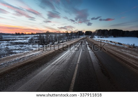 Dirty asphalt road with mix of snow, sand and salt