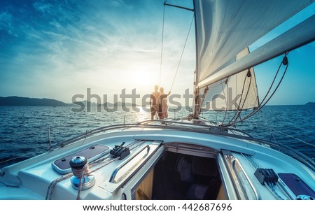 Young couple enjoying sunset on the yacht in Andaman sea