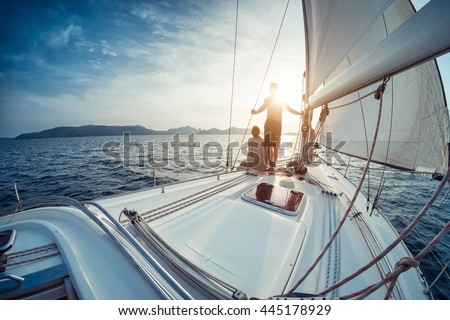 Young couple looking to the sunset on the yacht in Andaman sea