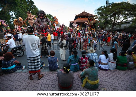 BALI, INDONESIA - MARCH 22: People on square ready to start Hindu Ngrupuk parade on March 22, 2012 in Ubud, Bali. Hindu Ngrupuk rituals  is performed in order to vanquish the negative spirits