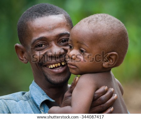 DZANGA-SANHA FOREST RESERVE, CENTRAL AFRICAN REPUBLIC - NOVEMBER 5, 2008: Papa with a child from a tribe of pygmies. Dzanga-Sangha Forest Reserve, Central African Republic, November 5, 2008