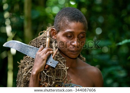 DZANGA-SANHA FOREST RESERVE, CENTRAL AFRICAN REPUBLIC - NOVEMBER 2, 2008: A woman from a tribe of pygmies in the forest. Dzanga-Sangha Forest Reserve, Central African Republic, November 2, 2008