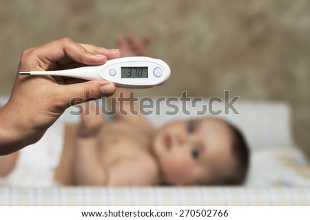 baby thermometer to measure the temperature of a sick child