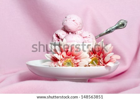 Strawberry ice cream dessert with strawberry Gerber flowers surrounding it on dish