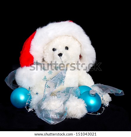 Santa Teddy Bear surrounding with holiday blue decorations
