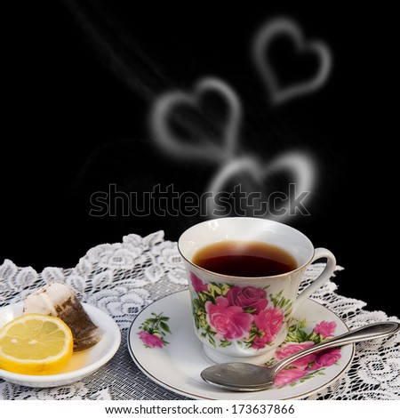Valentine Hearts of smoke coming from romantic cup of tea with lemon slice to the side