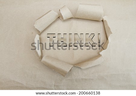 PAPER BAG WITH HOLE RIPPED AND PIECES ROLLED BACK FOR WITH TEXT IN MIDDLE, THINK!  CONCEPT
