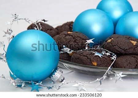 Chocolate Cake Cookies with peanut butter chips and aqua Christmas ornaments served on a glass plate for the holidays