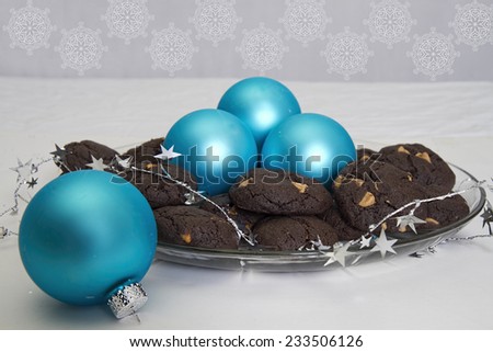 Chocolate Cake Cookies with peanut butter chips and aqua Christmas ornaments served on a glass plate for the holidays