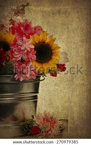 Background with country bucket filled with flowers including sunflowers.  Image has the use of textures and filters for added interest.
