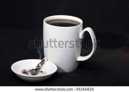 Coffee and cigarette tapped out in ashtray