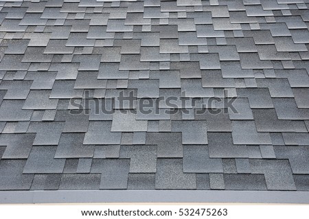 Close up view on Asphalt Roofing Shingles Background. Roof Shingles - Roofing. Bitumen tile roof.
