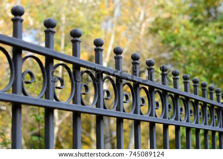Beautiful wrought fence. Image of a decorative cast iron fence. metal fence close up. Metal Forged Fence.