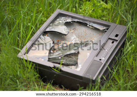 Electronic waste broken tv cathode ray tube on grass