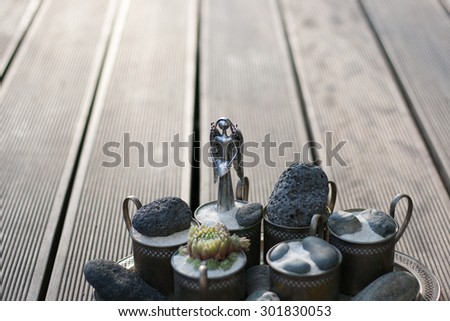 buddhistic still life with angel and stones and houseleek flower and sand and tiny rocks in zen style