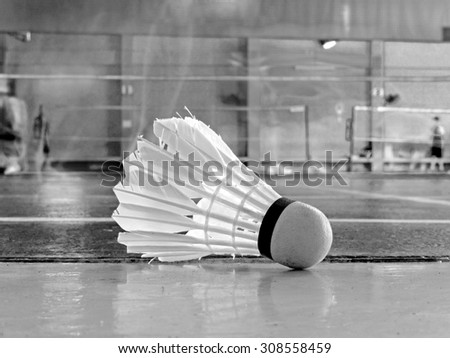 Shuttlecock for badminton on floor when people play badminton in court, black and white style