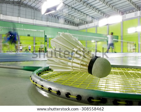Shuttlecock and racket for badminton on floor when people play badminton in court