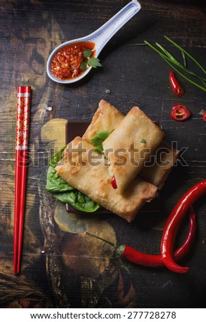 Fried spring rolls with  shrimps, bok choi, chili pepper, hot sauce on a vintage ceramic plate