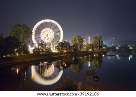 Mirror reflection of giant ferris wheel