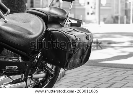 Szeged, Hungary - May 30th, 2015: Photo shoot of Yamaha Drag Star 1100 XVS bike from 2002, closeup shoot of seat and saddlebags. 4-stroke SOHC V-twin engine, 1063cc. Black and white photo.