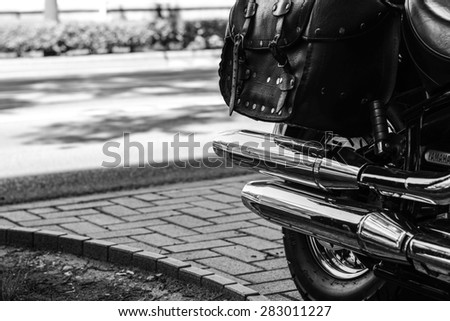 Szeged, Hungary - May 30th, 2015: Photo shoot of Yamaha Drag Star 1100 XVS bike from 2002, closeup shoot of a chromed exhaust and saddlebags.4-stroke SOHC V-twin engine, 1063cc.Black and white photo.
