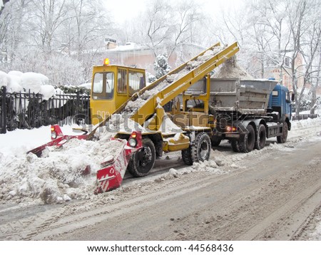 Snow-removal machine cleans the street of snow