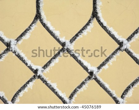 Part of decorative lattice covered with snow, close-up