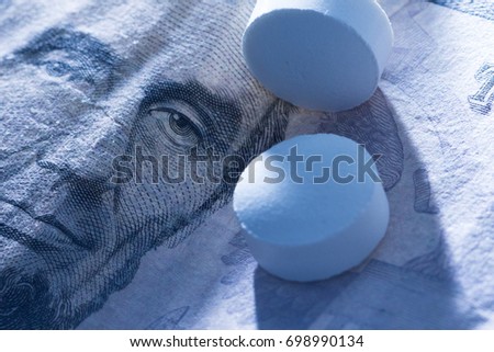Abraham Lincoln on American dollar pill next to pills medication prescription. Cost of health care and standards of pharmaceutical business and investment economy.
