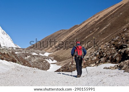Young man on the hiking path in the mountains of Nepal - Himalayas. Background High mountains