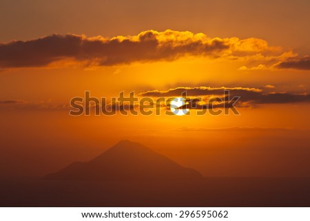 Italy, Sicily, Stromboli silhouette on sunset