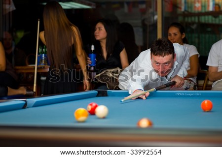 BANGKOK - JULY 18 2009: Snooker pro Jimmy White plays 9 ball for fun in a small pool bar July 18, 2009 in Bangkok.