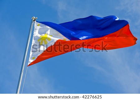 stock photo philippine flag on a pole against blue sky