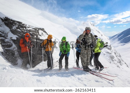 Murmansk region,Russia - April 11, 2013:A group of russian tourists caught in bad weather during ski travel in Hibiny mountains. Team leader communicates by radio with the base to receive instructions