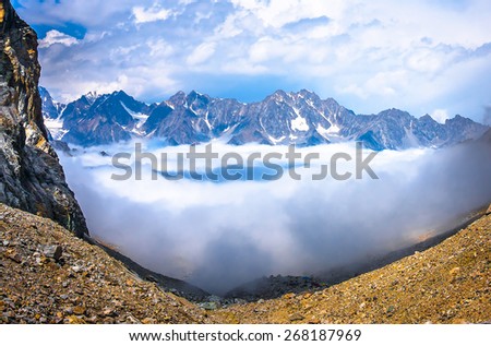 Above the clouds in the mountains. Picture was taken during a trekking hike in gorgeous Caucasus mountains, Bezengi region, Kabardino-Balkaria, Russia.