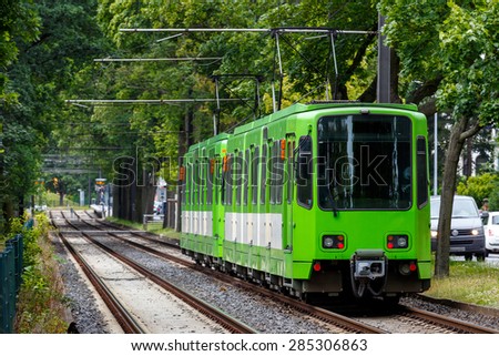 Tram car running along the line of tree in Hannover, Germany