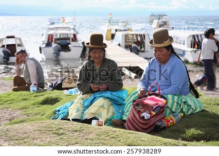 Titicaca lake, Bolivia - January 2: Bolivian women chew coca leaves near ferry Copacabana, Bolivia on January 2,2009.Bolivia obtained exemption from 1961convention,allowing native people to chew coca