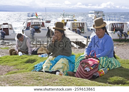 Titicaca lake, Bolivia - January 2: Bolivian women chew coca while waiting for  ferry Copacabana, Bolivia on January 2,2009. Chewing coca is legal in Bolivia.