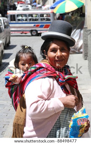 LA PAZ, BOLIVIA-JAN. 5: An unidentified woman carries her baby in traditional sling January 5, 2009 in La Paz, Bolivia. Bolivian women use slings for centuries but now strollers compete with slings.