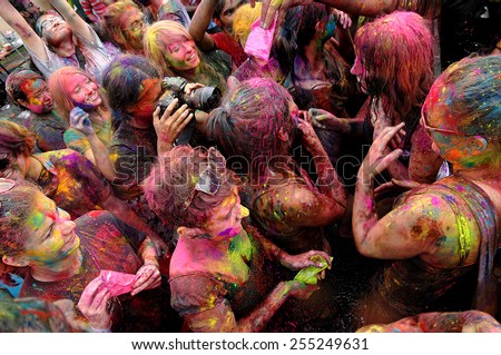 KUALA LUMPUR, MALAYSIA - MARCH 18: Photographer and people covered in paint on Holi festival, March 18, 2013, Malaysia. Holi festival of colors, being one of the biggest festivals in Malaysia.
