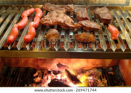 Making barbecue  Steak and sausage over high heat.