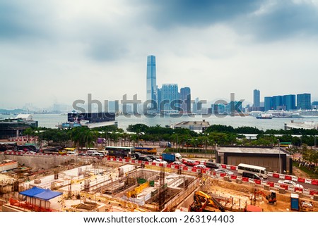Hong Kong, Hong Kong SAR -November 12, 2014: Building site and the Central Piers area in Hong Kong. ICC and another high rise buildings at the opposite side of the Victoria Bay.