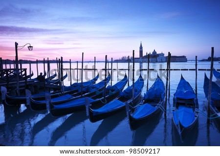 San Giorgio Maggiore church and gondolas at dawn in Venice.