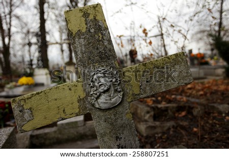 Old cross on one of the graves