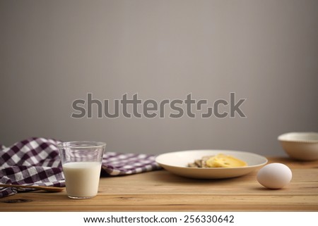 Minimalistic breakfast table with milk and eggs