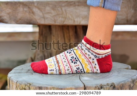 Cropped view of woman putting her feet in warm comfy socks on windowsill  with book and coffee, closeup Stock Photo - Alamy