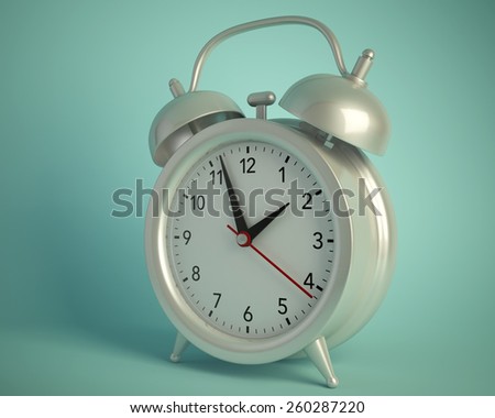 silver alarm clock on a green background