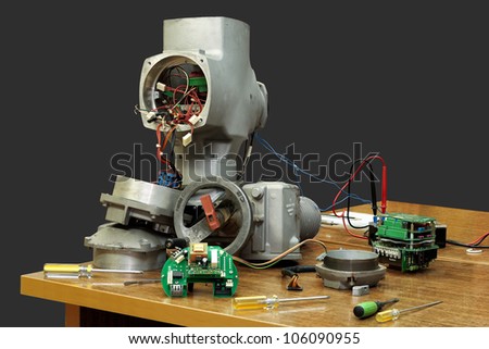 Dismantled industrial electronic gate, isolated on a gray background.